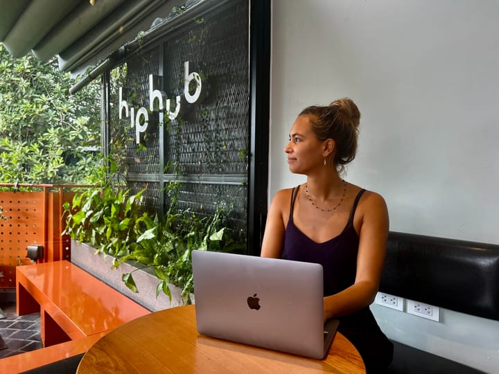 Lau sitting with an Apple Macbook Pro at Hiphub café in Hanoi, Vietnam